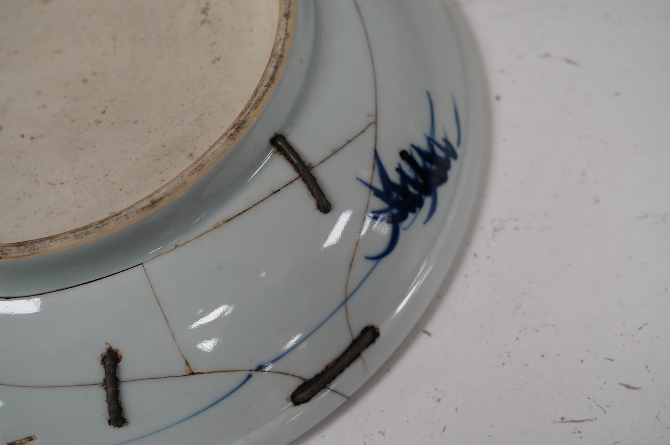 A Chinese underglaze blue and red and green enamelled 'horses' dish, Yongzheng period, 28.5cm. Condition - poor